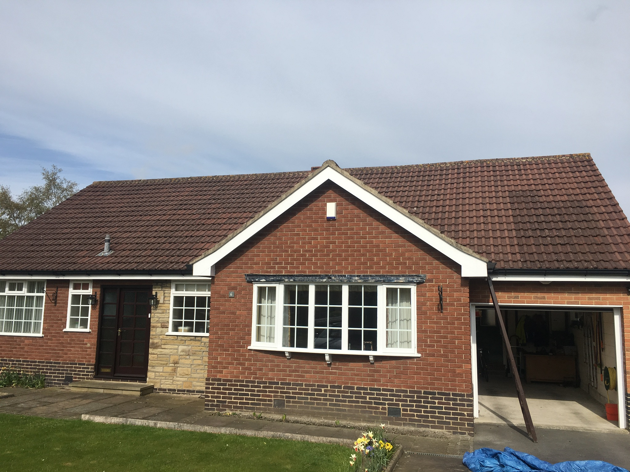 after moss and surface dirt have been removed from concrete-tiled roof