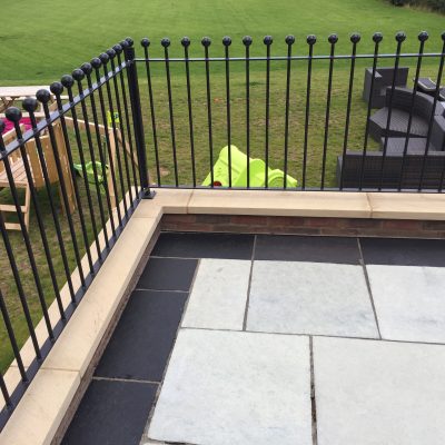 The same patio after cleaning, with the black limestone border returned to a deep charcoal appearance.