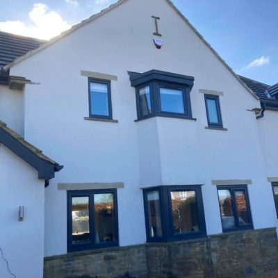 White rendered house façade after softwash cleaning and algae removal in Leeds.